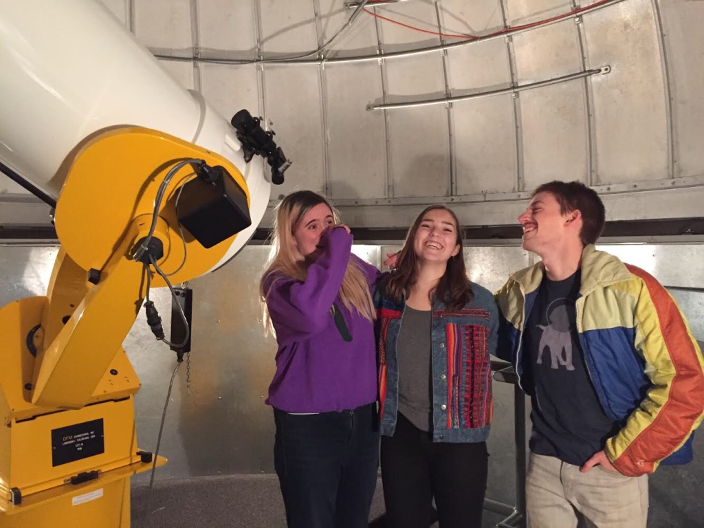 Hosts Catie Ball, Riley McGlasson, and Alex Gordon with the Macalester telescope.